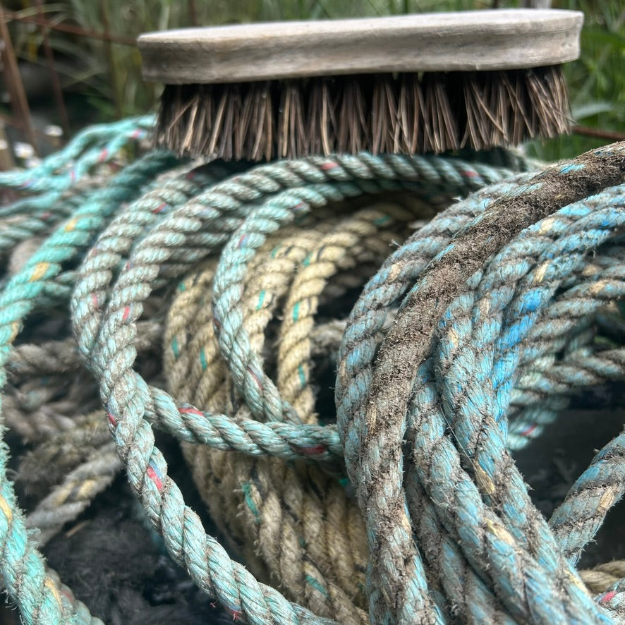 Close up shot of a pile of dirty, reclaimed fishing ropes ready to be scrubbed clean and reworked by hand into sustainable ocean inspired art.
