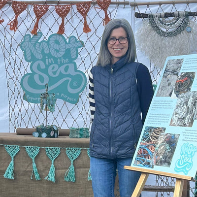This is me on my Knot in the Sea stall at Croyde Village Sunday Market with sustainable macrame bunting and wall hanging created with repurposed fishing rope.