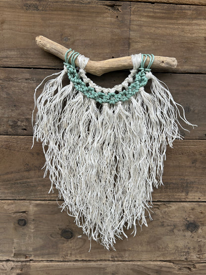 Repurposed reclaimed fishing rope hand-knotted into textured marine rope wall art on driftwood.