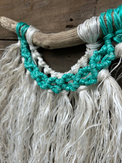 Close-up of vibrant sea-green circles created from hand-knotting retired fishing ropes into eco-friendly ocean inspired wall art.