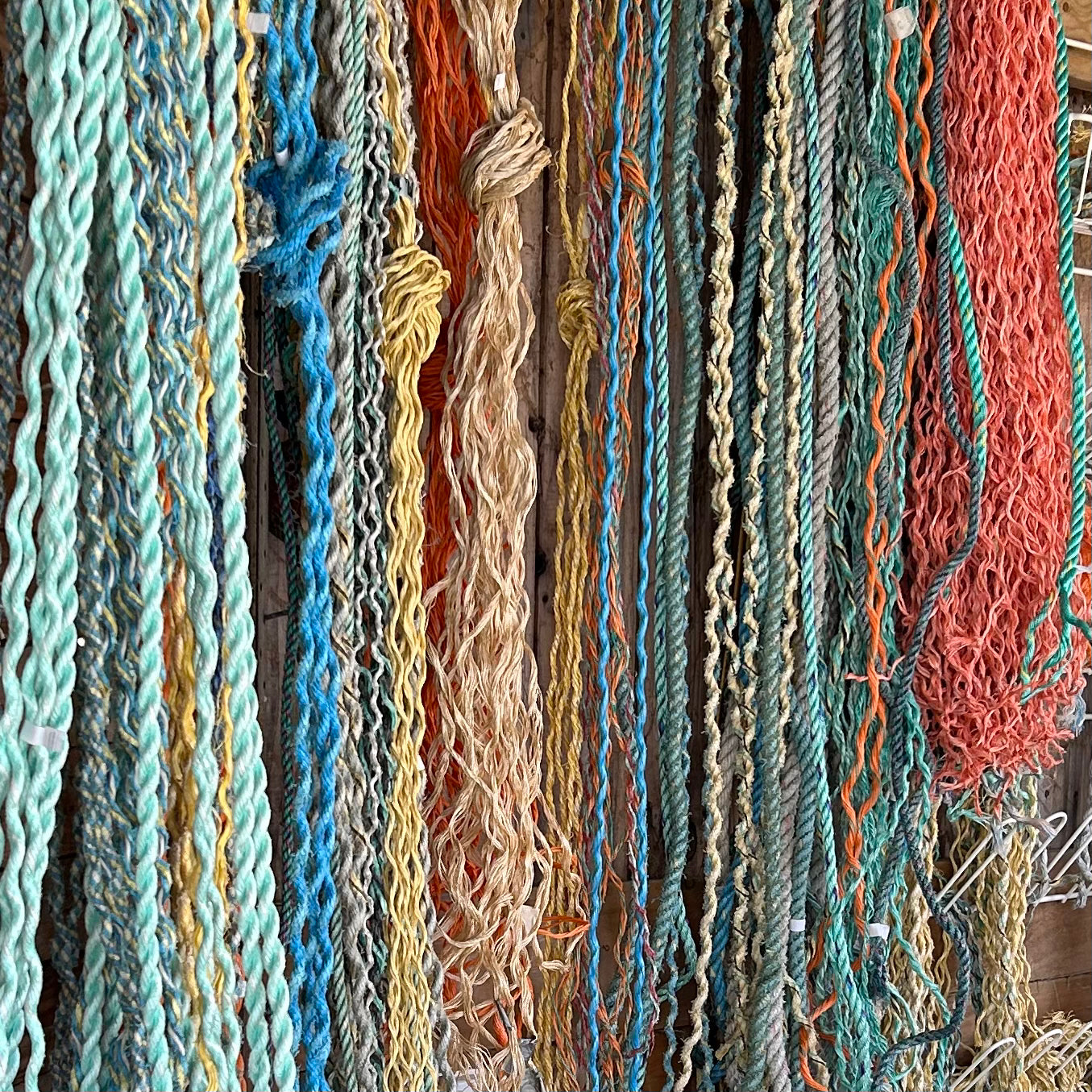 Reclaimed fishing ropes in the workshop showing different stages of preparation before being transformed into coastal rope wall art.