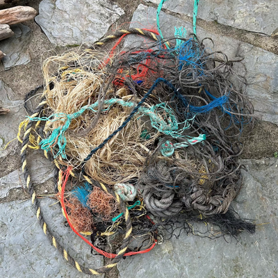 Knotted pile of ghost gear discarded beach-combed ropes needing untangling and cleaning before being transformed into unique eco-friendly art.