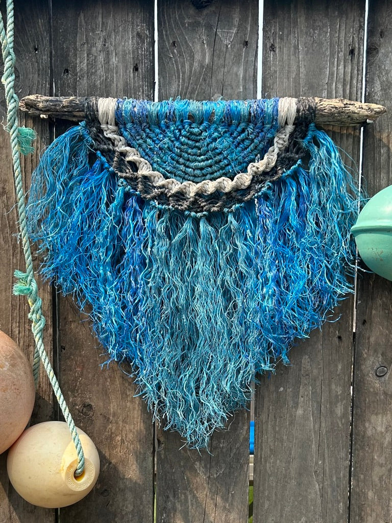 multi-textured coastal wall hanging handmade with reclaimed lobster pot rope in weathered tones of ocean blue, white and black.